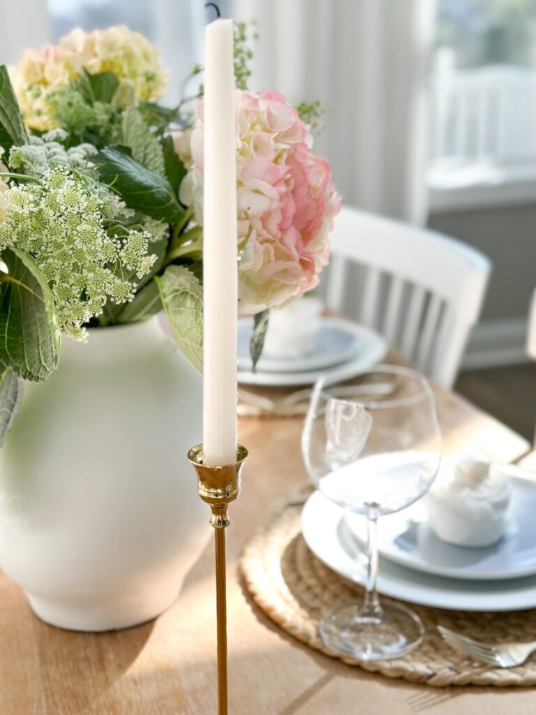 flower arrangement, candles and place setting for girly celebration