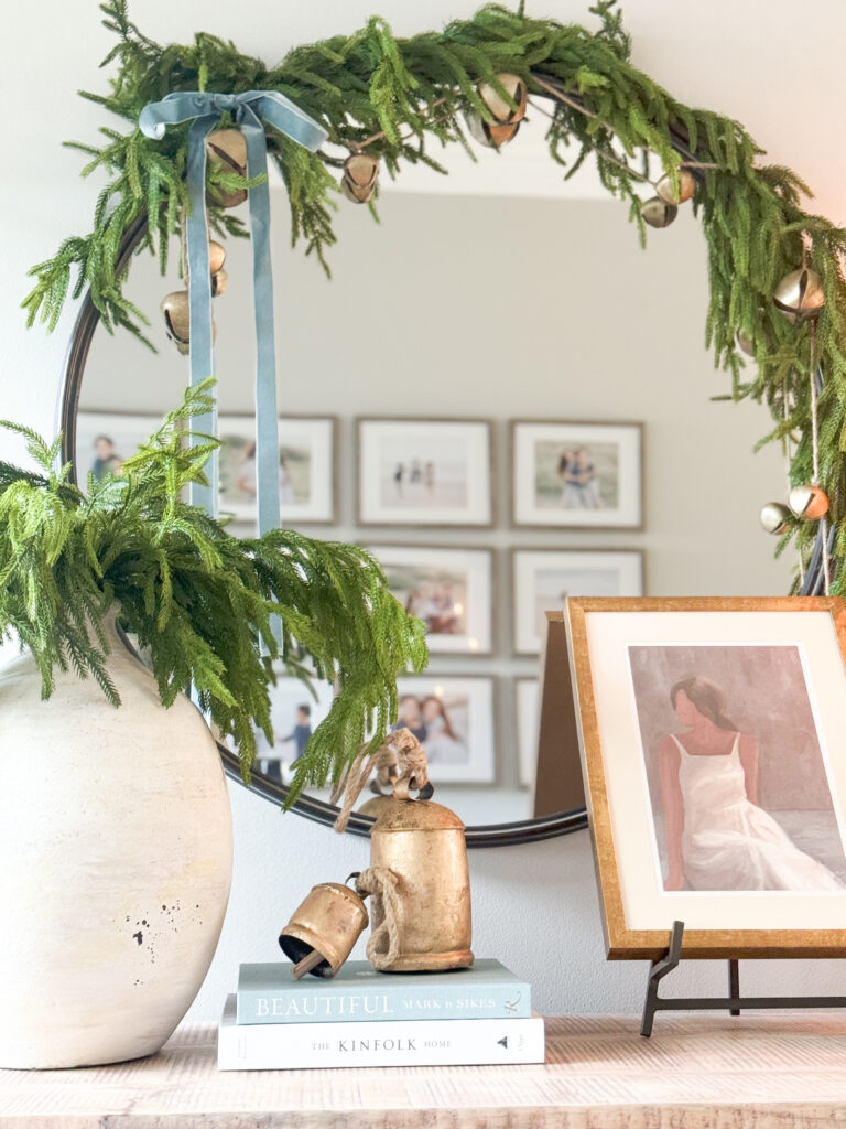 decorated mirror with greenery and velvet ribbon